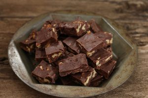 Homemade chocolate pumpkin fudge squares with nuts