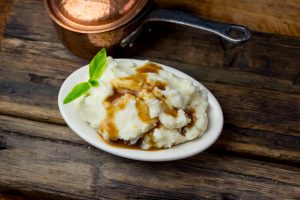 Vegan Mashed Potatoes with Gluten-Free Gravy on Old Wooden Table