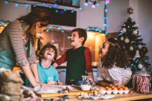 Mother and Three Children Deciding on Holiday Recipes to Bake | Vitacost.com/blog