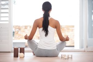Woman Meditating in Front of Window to Improve Health | Vitacost.com/blog