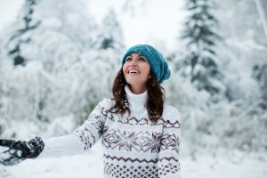 Happy Woman in Blue Hat and White Sweater in Snowy Landscape | Vitacost.com/blog