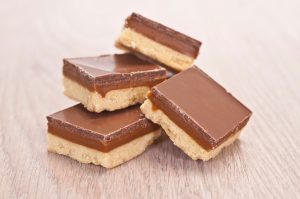 Four Chocolate-Caramel No-Bake Dessert Squares Stacked on Table | Vitacost.com/blog