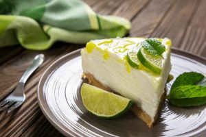 No-Bake Key Lime Pie Slice on Plate with Lime Wedges | Vitacost.com/blog