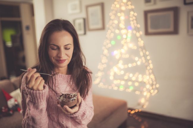Woman Enjoying Healthy Snacks in Holiday-Decorated Living Room | Vitacost.com/blog