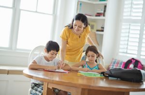Kids at Table Working on New Year's Resolution to Finish Homework Early | Vitacost.com/blog