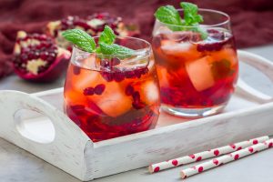 Glasses with Pomegranate Mocktail Garnished with Mint Leaves in Tray | Vitacost.com/blog