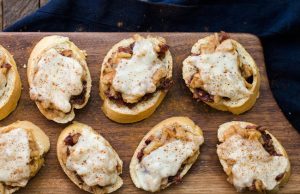 Homemade Pear and Manchego Crostini with Caramelized Onions on Cutting Board | Vitacost.com/Blog