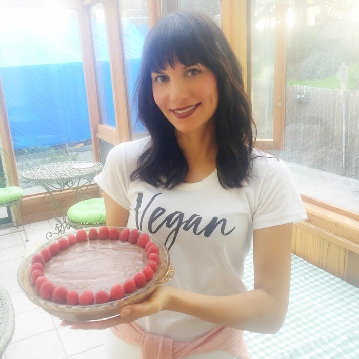 Jessica Remmers of HealthyHappyJess Holding Homemade Raw Vegan Cake | Vitacost.com/Blog