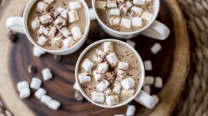 Overhead View of 3 White Mugs Filled with Vegan Gingerbread Hot Chocolate & Mini Marshmallows on Wood Plank | Vitacost.com/blog