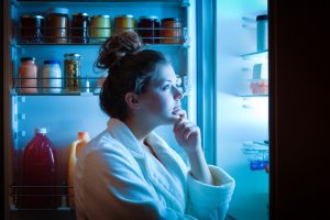 Woman Stress Eating Looking in Refrigerator in Middle of Night | Vitacost.com/blog