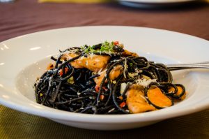 Black Bean Noodles in a White Bowl with Salmon | Vitacost.com/blog