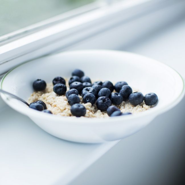 Slow Cooker Oatmeal with Honey Sea Salt Slow Cooker Oatmeal with Steel Cut Oats & Blueberries in White Bowl on Windowsill #recipe | Vitacost.com/blog
