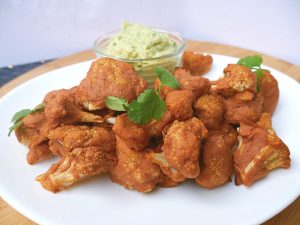 Vegan Cauliflower Hot Wings on a White Plate with Vegan Dipping Sauce #recipe | Vitacost.com/blog