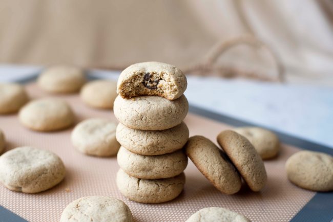 5 Butterbeer Cookies Stacked on Top of Each Other on Parchment-Lined Baking Sheet #recipes | Vitacost.com/blog