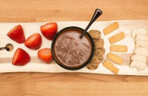 Bowl of Chocolate Dessert Hummus Recipe on Plank with Strawberries & Cookies for Dipping | Vitacost.com/blog