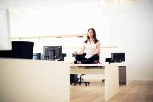 Business Woman Doing Relaxing Yoga on Her Desk | Vitacost.com/blog