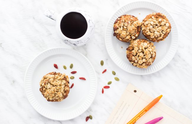 Morning Glory Muffins (Gluten-Free) 4 Morning Glory Muffins on Two White Plates with a Mug of Coffee & Seeds on White Tablecloth #recipe| Vitacost.com/blog
