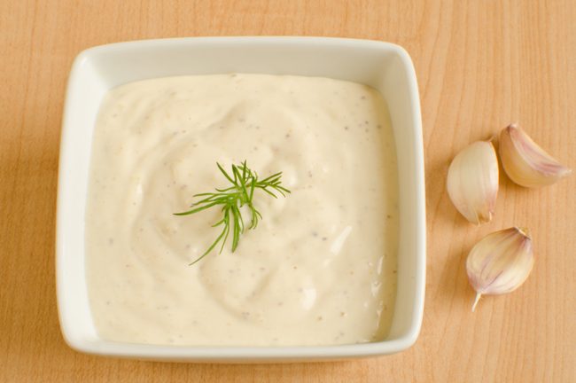 Cashew Cream Garlic Aioli Cashew Cream Aioli in a Square Dish with Garlic Cloves | Vitacost.com/blog