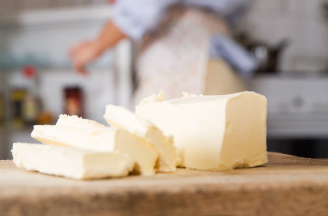 Sliced Sticks of Butter on Wooden Cutting Board as Example of Dietary Fats | Vitacost.com./blog
