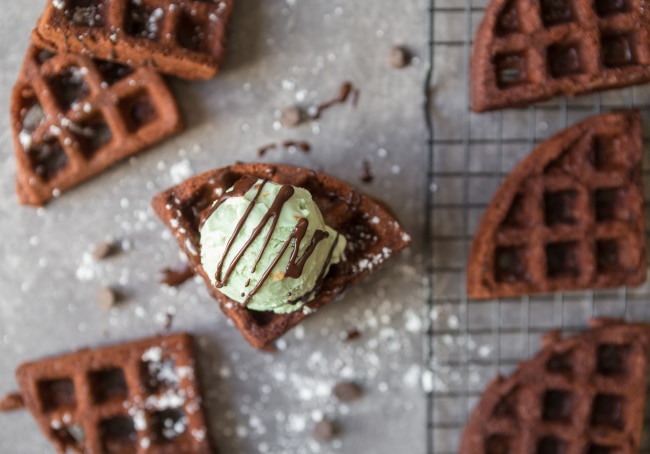 Mocha Brownie Waffles with Pistachio Gelato Brownie Waffles with Pistachio Gelato on Counter & Cooling Rack with Powdered Sugar Dust & Chocolate Drizzle #recipe | Vitacost.com/blog