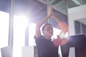 Female Executive Doing Yoga at Desk to De-Stress | Vitacost.com/Blog