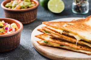 3 Brie Quesadilla Wedges Stacked on a Plate | Vitacost.com/blog