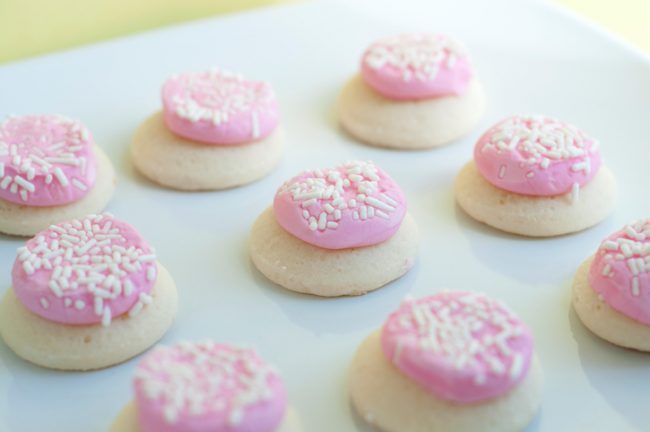 Coconut Cookies with Frosting | Vitacost Blog Coconut sugar cookies with pink frosting and white sprinkles on a plate | Vitacost.com/blog