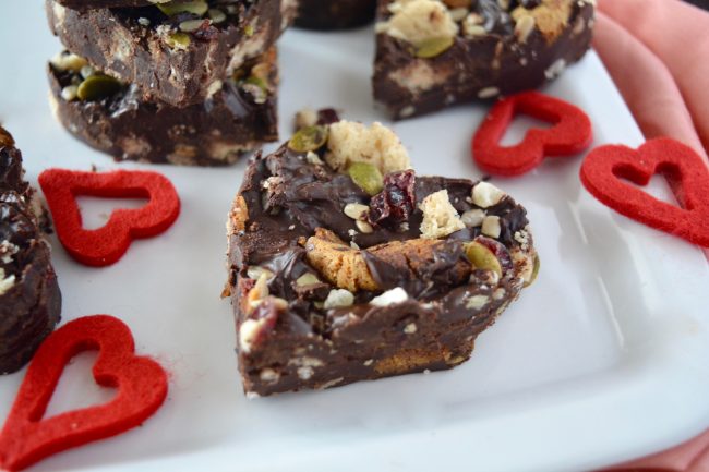 Heart-Shaped, Dairy-Free Chocolate Dessert: Kitchen Sink Bark on White Plate with Red Felt Heart Cut-Outs | Vitacost.com/blog