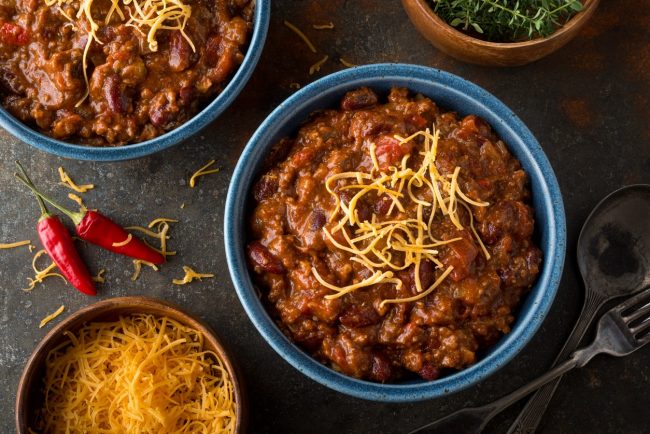 Slow Cooker Chipotle Turkey Chili  Slow Cooker Chipotle Turkey Chili with Shredded Cheese in Blue Bowl on Countertop #recipe | Vitacost.com/blog