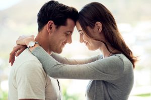 Couple Practicing Humility Embracing With Eyes Closed and Content Smiles | Vitacost.com/blog