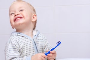 Happy Young Boy Learning How to Brush Baby Teeth | Vitacost.com/blog