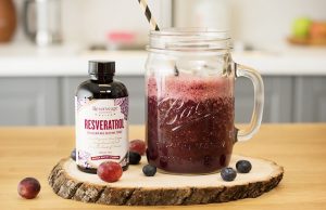 Ball Jar with Kombucha Pomegranate Smoothie Recipe, Featuring Reserveage Resveratrol, Blueberries & Red Grapes on Wood Plank | Vitacost.com/blog