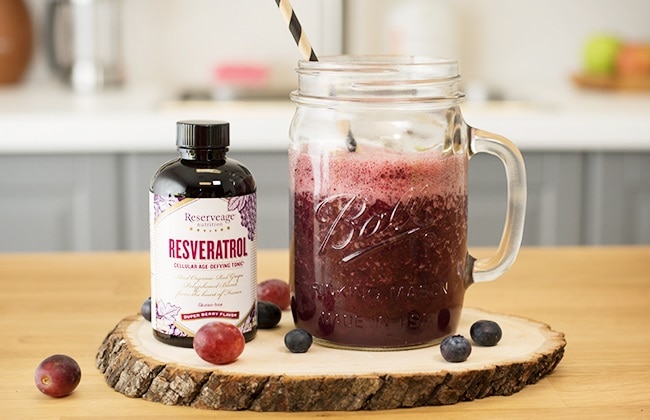 Ball Jar with Kombucha Pomegranate Smoothie Recipe, Featuring Reserveage Resveratrol, Blueberries & Red Grapes on Wood Plank | Vitacost.com/blog