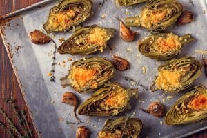 Roasted Artichokes on Baking Sheet with Vegan Cheese Sauce | Vitacost.com/blog