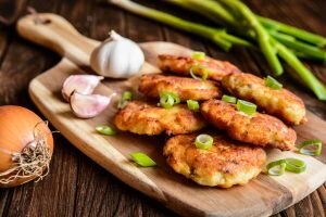 Six Fish Burger Patties with Scallions on a Wooden Board | Vitacost.com/blog