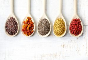 Natural Stress Relief Superfoods Displayed in Wooden Spoons on Table