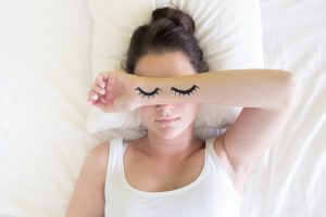 Woman in Bed Experiencing Improved Sleep After Trying Natural Remedies | Vitacost.com/Blog