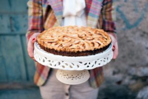 Woman Serving Homemade Pie for Pi Day | Vitacost.com/Blog
