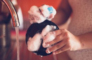 Person Standing at Sink Enjoying Washing Dishes | Vitacost.com/Blog