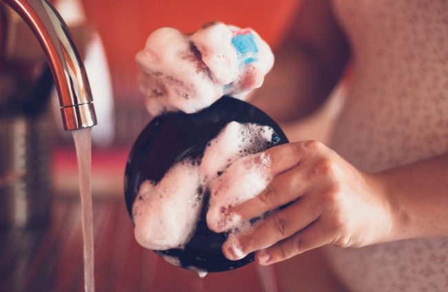 Person Enjoying Washing Dishes | Vitacost.com/Blog