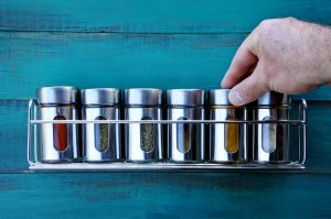 Person Replacing Old Spices in Spice Rack | Vitacost.com/Blog