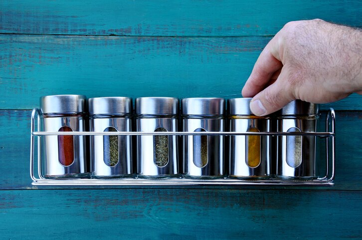 Person Replacing Old Spices with New Ones in Spice Rack | Vitacost.com/Blog