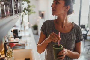 Teen Girl Drinking Green Juice While Transitioning to Vegan Diet | Vitacost.com/Blog