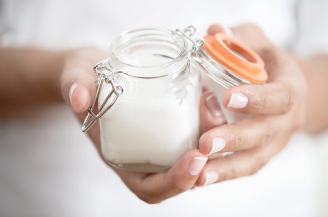 Woman Holding Small Jar Filled With Homemade DIY Breastfeeding Cream | Vitacost.com/blog