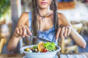 Woman Eating a Salad for Lunch Follows the Nutritarian Diet by Dr. Fuhrman | Vitacost.com/blog