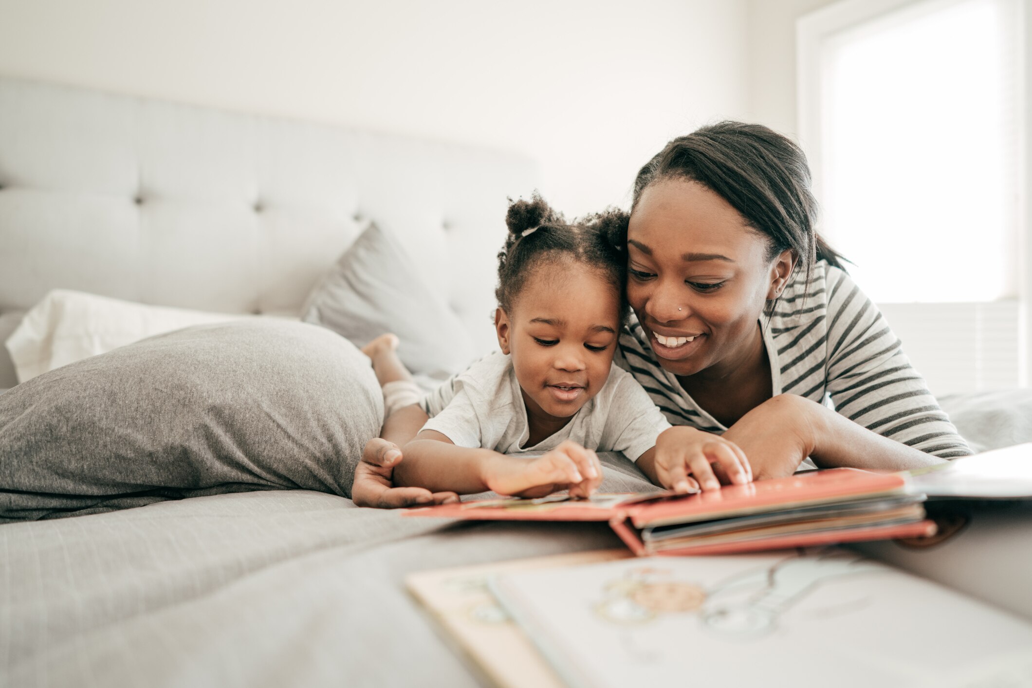 Mindful mom and toddler reading a book