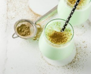2 Glasses of Spirulina Coconut Homemade Electrolyte Smoothie on White Table with Spirulina Powder #recipe | Vitacost.com/blog