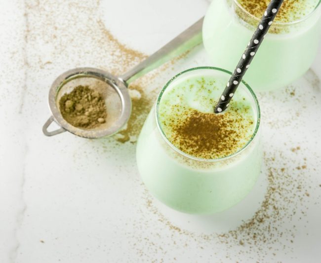 2 Glasses of Spirulina Coconut Homemade Electrolyte Smoothie on White Table with Spirulina Powder #recipe | Vitacost.com/blog