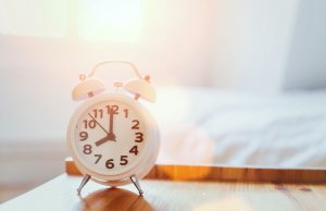 Alarm Clock on Nightstand Beside Someone Getting a Good Night's Sleep | Vitacost.com/blog