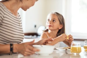 Child Who is Picky Eater Trying New Food at Table with Mother | Vitacost.com/blog